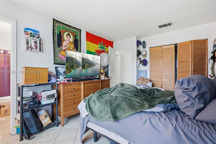 Interior space featuring tile flooring and louvered bifold closet doors