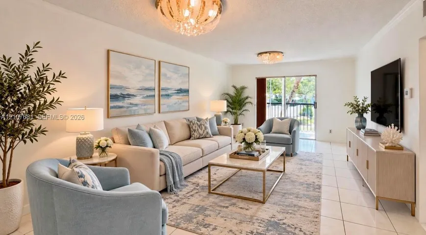 Living area featuring light-colored tile flooring, crown molding, two ornate glass-accented ceiling fixtures, and a glass sliding door