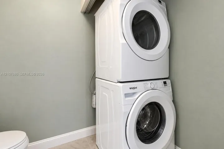 Stacked white front-load washer and dryer unit