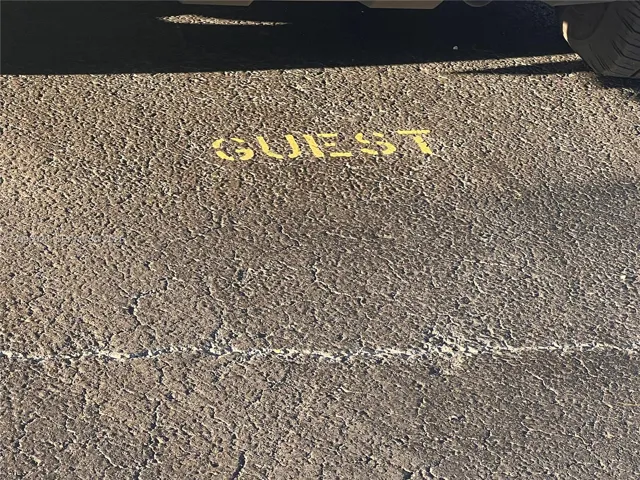 Asphalt parking surface with designated yellow-painted marking
