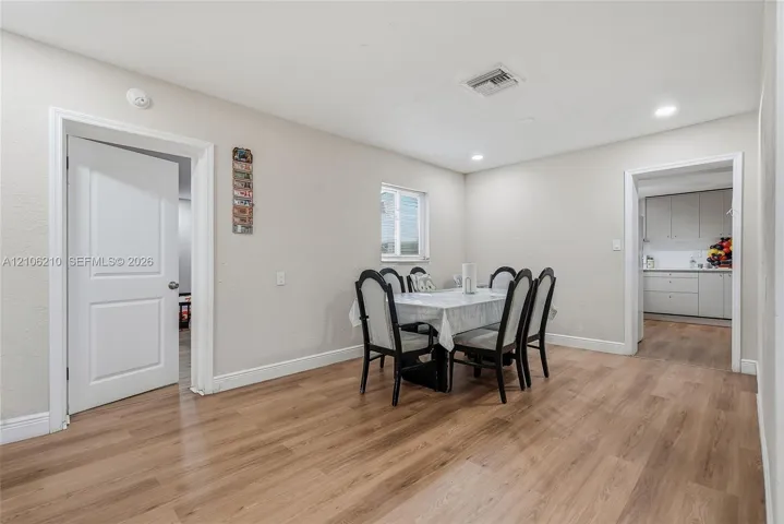 Dining area featuring wood-finish flooring, recessed lighting, and a single-pane window