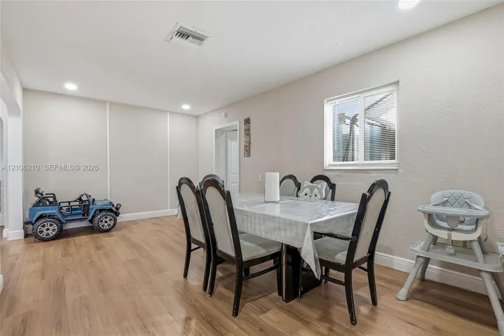 Interior space featuring wood-finish flooring, recessed lighting, and a dual-pane window
