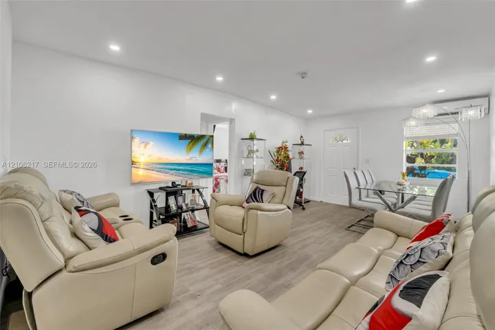 Open-concept interior featuring wood-finish flooring, recessed lighting, and a ductless mini-split climate control system