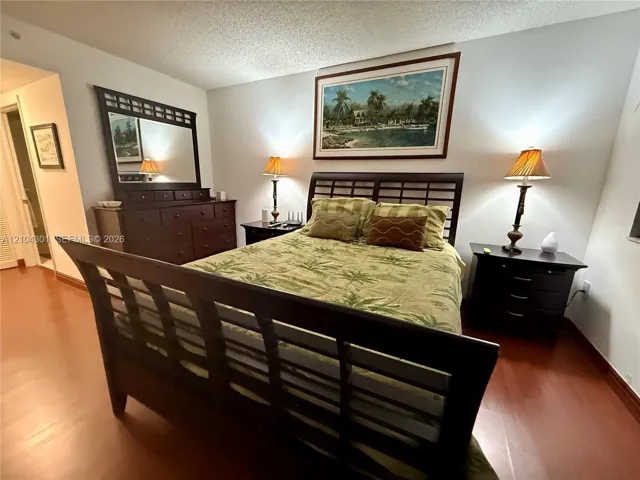 Bedroom featuring wood-finish flooring and neutral wall color