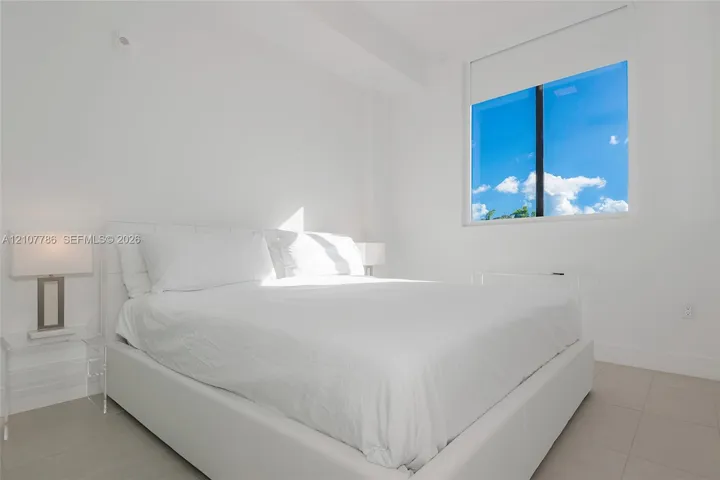 Bright interior space featuring large rectangular windows, neutral tile flooring, and clean-finish walls