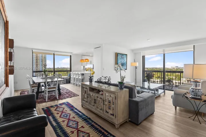 Open-concept living space featuring wood-finish flooring, floor-to-ceiling windows, and recessed lighting