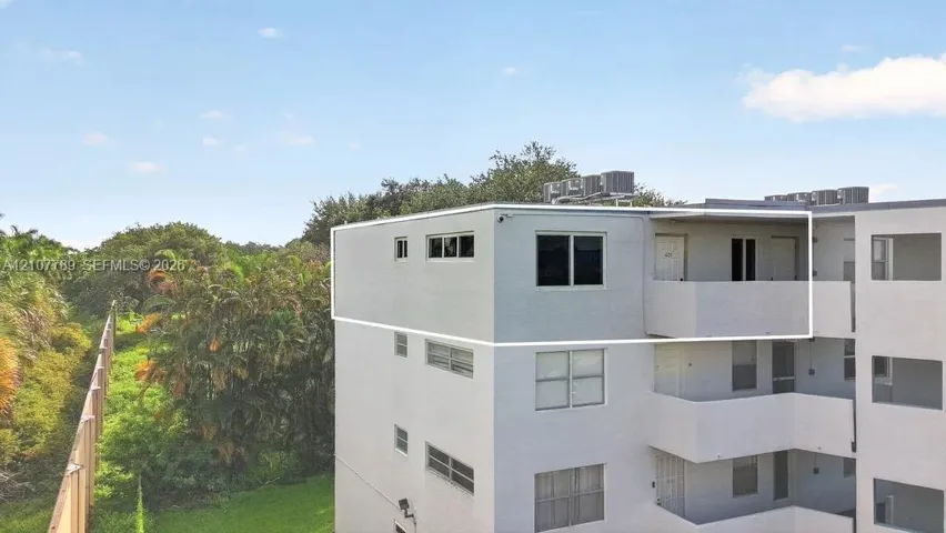 Top-floor unit featuring a private balcony, horizontal sliding windows, and exterior stucco finish