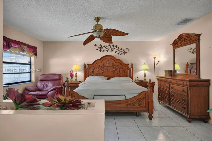 Ceramic tile flooring and a ceiling fan with leaf-shaped blades