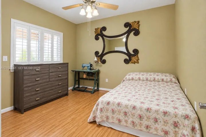 Wood-finish flooring, plantation shutters, and a multi-light ceiling fan