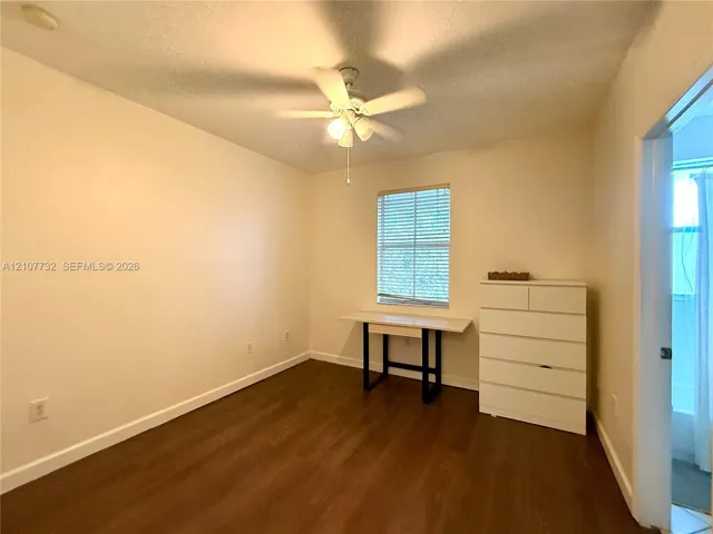 Wood-finish flooring, ceiling fan with integrated lighting, and horizontal window blinds