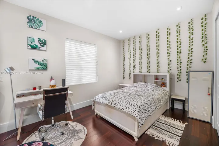 Interior space featuring wood-finish flooring, recessed lighting, and a window with horizontal blinds