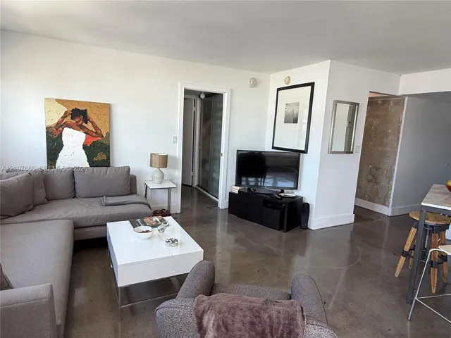 Polished concrete flooring, exposed concrete wall finish, and neutral interior wall palette
