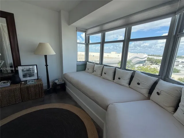 Built-in window bench with tailored upholstery and expansive multi-pane windows