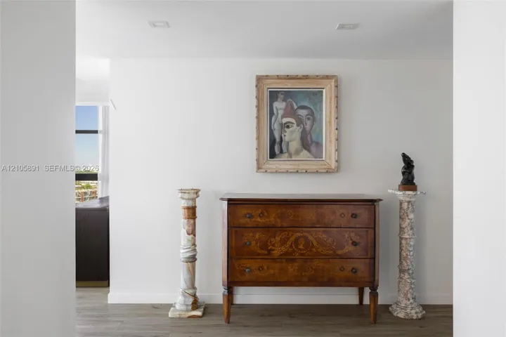 Neutral-toned walls and wood-finish flooring with recessed ceiling lighting