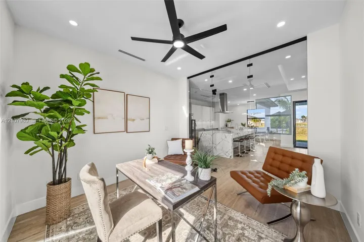 Interior space featuring wood-finish flooring, recessed lighting, and a modern black ceiling fan