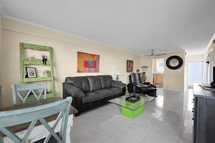 Large-format ceramic tile flooring, ceiling fan with light fixture, and recessed entry door
