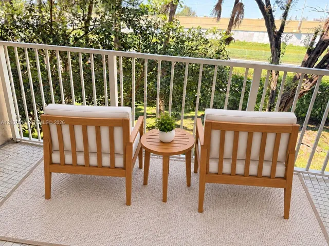 Private balcony featuring a white metal railing and square tile flooring
