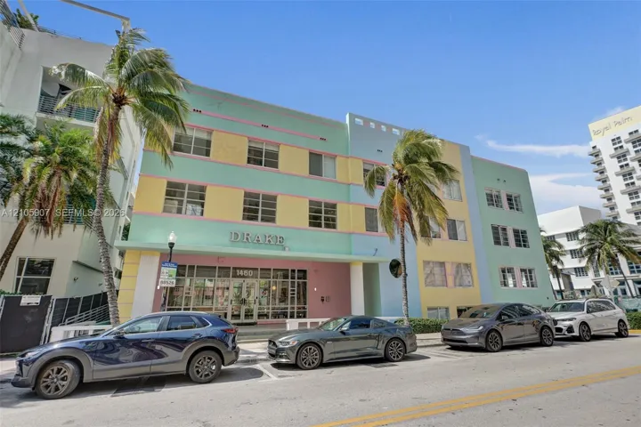 Art Deco exterior featuring a multi-story pastel facade, recessed window groupings, and a symmetrical geometric design