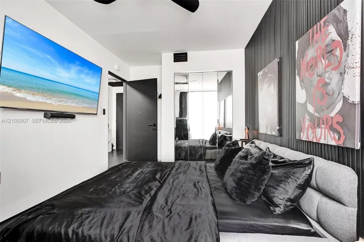 Vertical slat accent wall, mirrored closet doors, and solid-core black interior door
