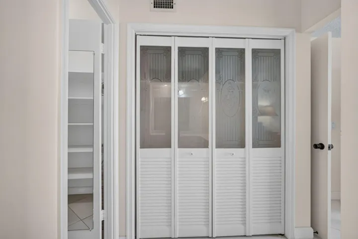 Primary Closet w/Venetian Bi-fold Doors