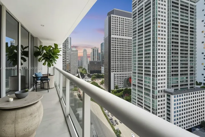 Covered outdoor balcony featuring a glass-panel railing, Virtually Staged