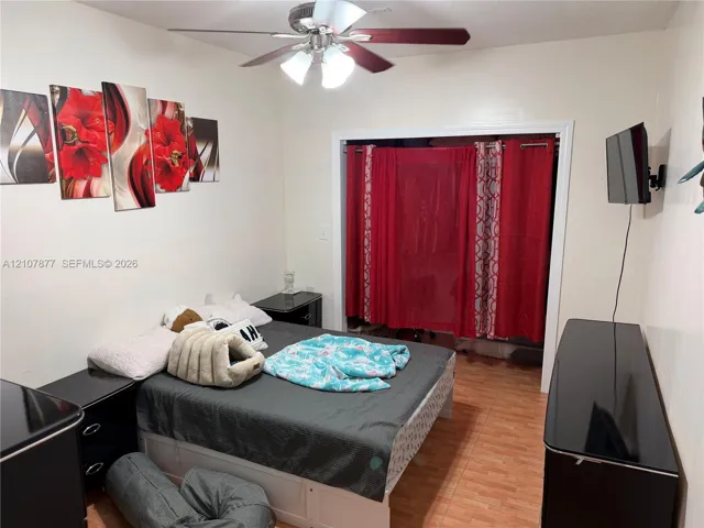 Room featuring tile flooring and a ceiling fan with integrated lighting