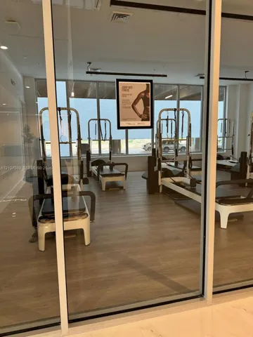 Fitness room featuring floor-to-ceiling windows, wood-finish flooring, and recessed ceiling lighting