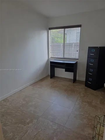Tile flooring, neutral wall tones, and window with horizontal blinds
