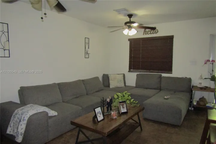 Ceiling fan with integrated lighting, recessed lighting, wood-finish flooring, and window with dark wood-toned blinds