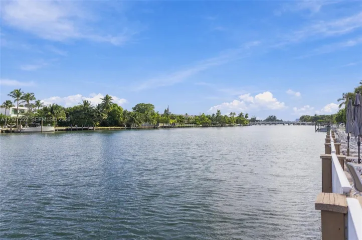 Waterfront property featuring a private bulkhead, expansive water frontage, and native palm trees