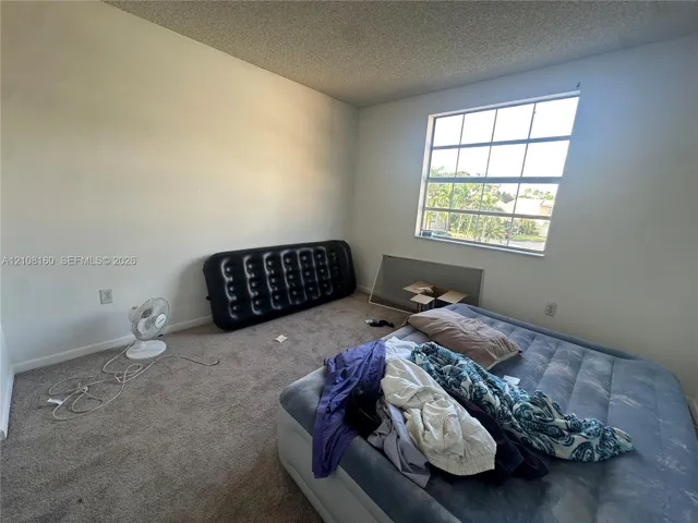Room featuring neutral wall finishes, carpeting, and a multi-pane window