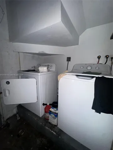 Dedicated laundry area featuring dual water hookups and an elevated concrete platform