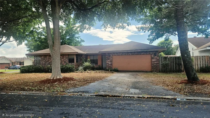 Single-story residence featuring a brick exterior, attached two-car garage, and mature landscaping