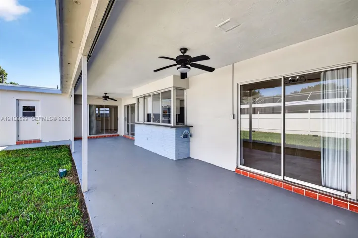 Backyard w/ covered patio & fans