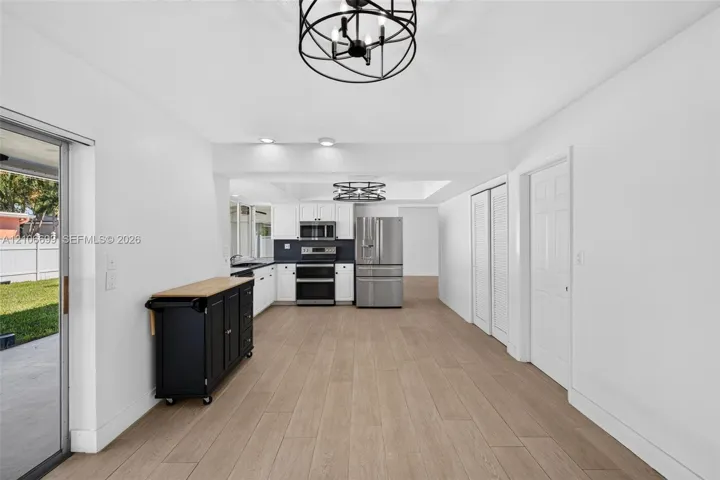 Open concept kitchen w/ updated plank wood look tile, stainless appliances approx 2020