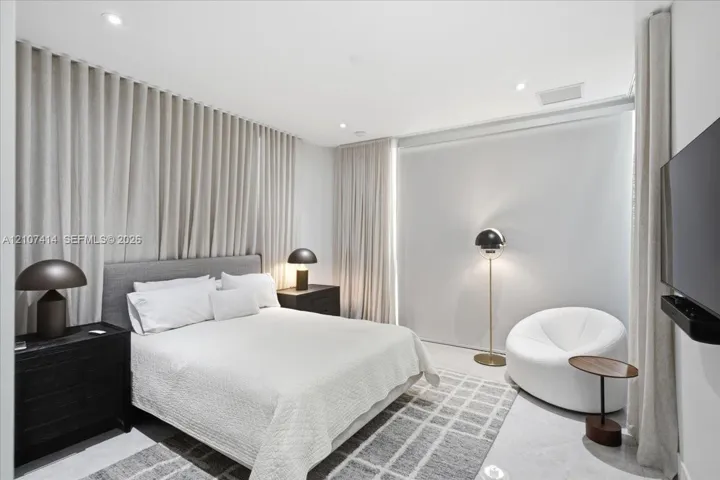 Wall-to-wall floor-to-ceiling drapery, recessed ceiling lighting, and smooth surface flooring