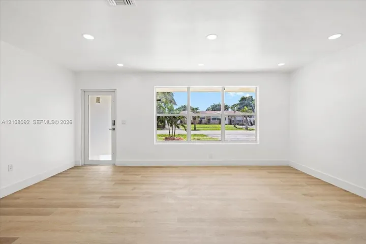Interior space featuring light-toned wood-finish flooring, recessed lighting, and a large picture window