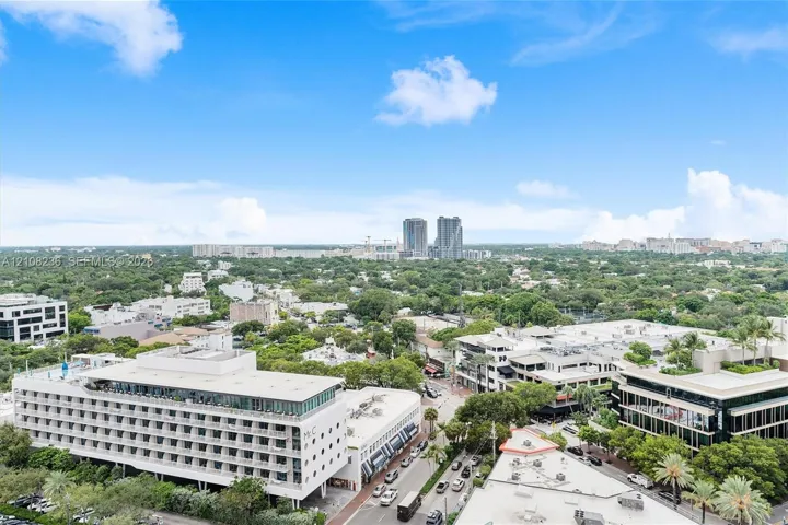 Elevated aerial perspective featuring metropolitan surroundings, mature tree canopy, and dense urban infrastructure