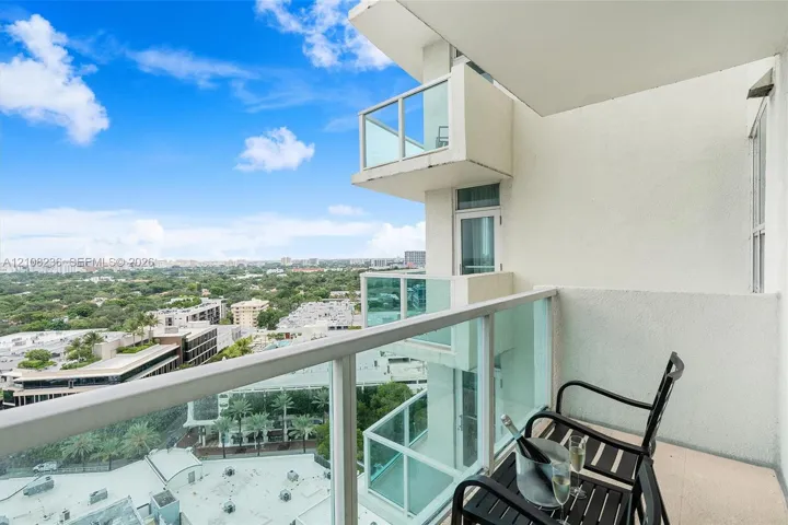 Private balcony featuring glass panel railings and expansive overhead perspective