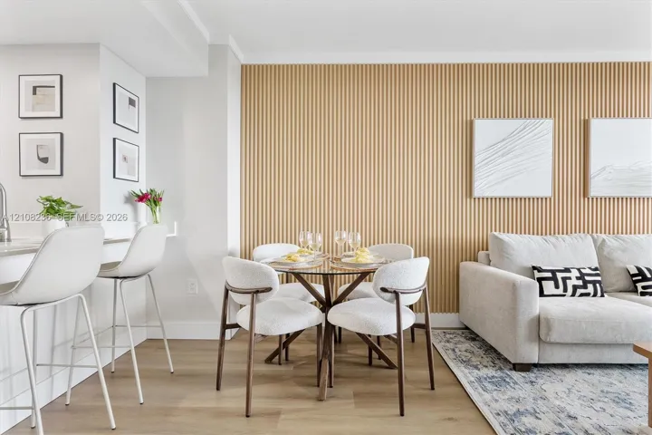 Vertical wood-slat accent wall featuring a neutral tone and smooth finish, paired with wood-finish flooring