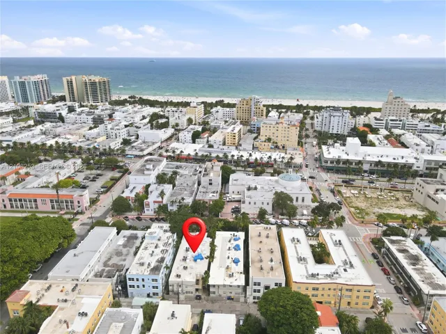 Aerial perspective featuring a multi-story urban building situated in a coastal metropolitan setting