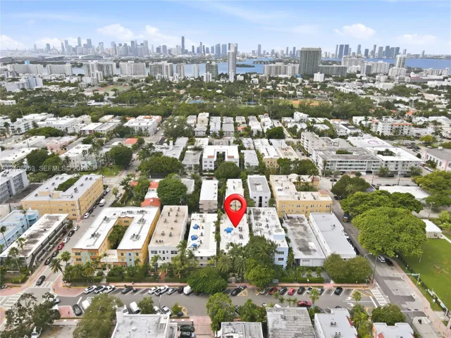 Aerial perspective showcasing an urban location with mature tree canopy and proximity to a metropolitan skyline