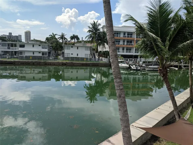 Waterfront bulkhead featuring concrete seawall and palm trees