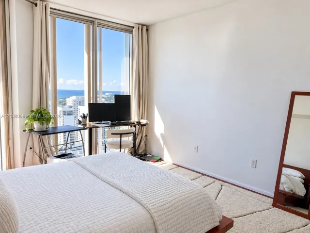 Floor-to-ceiling windows featuring expansive coastal and urban scenery