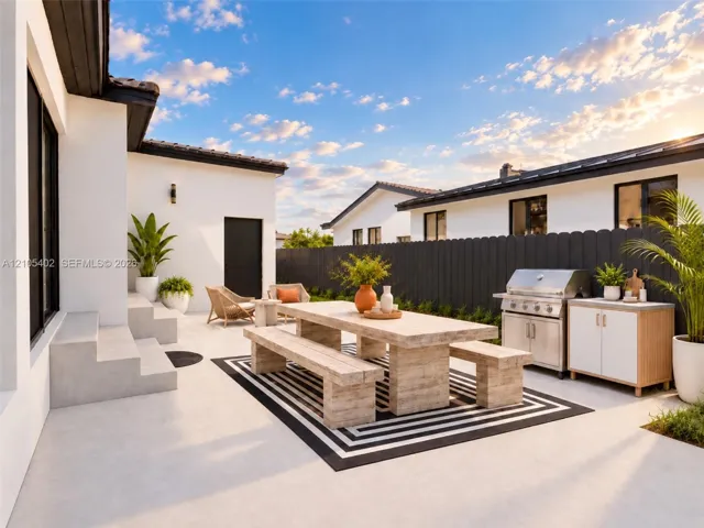 Outdoor patio featuring smooth concrete hardscaping, a stainless steel built-in grill, stone-finish cabinetry, and dark vertical wood fencing