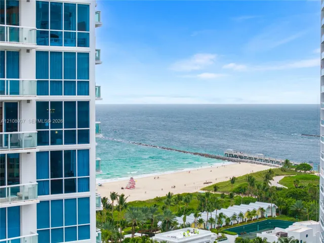 High-rise exterior featuring floor-to-ceiling glass windows and multiple private balconies