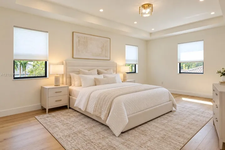 Tray ceiling featuring recessed lighting, light-toned wood-finish flooring, and multiple windows with cellular shades