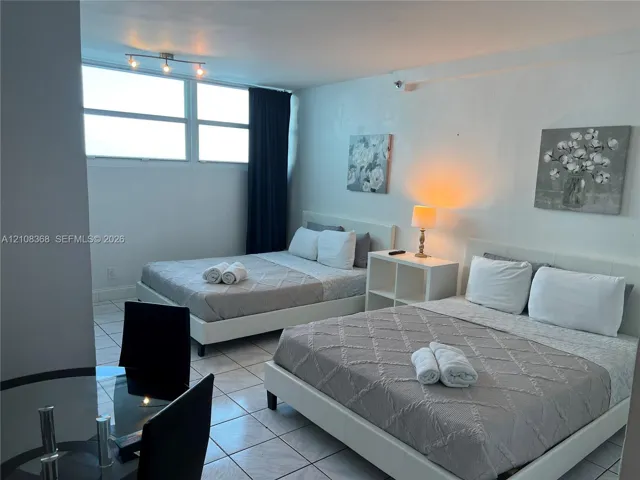 Tiled flooring and large multi-pane windows with adjustable track lighting