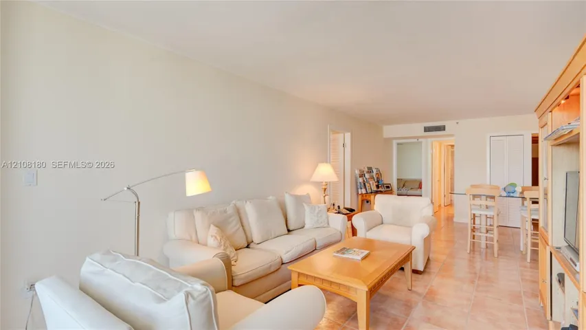 Open-concept living space featuring ceramic tile flooring, built-in cabinetry, and neutral wall tones