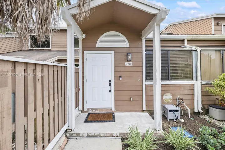 Covered entryway with a white front door